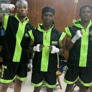 Three young boxers in black and green uniforms.