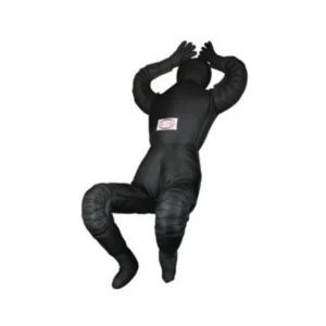 A black man in a suit is sitting on the ground