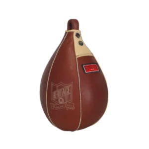 A brown and beige boxing bag is sitting on top of the floor.