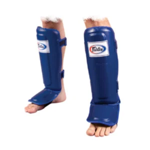 A person wearing blue shin guards and standing on their feet.