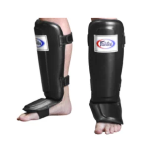 A pair of black shin guards on the feet.