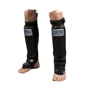 A pair of legs wearing shin guards and ankle protectors.